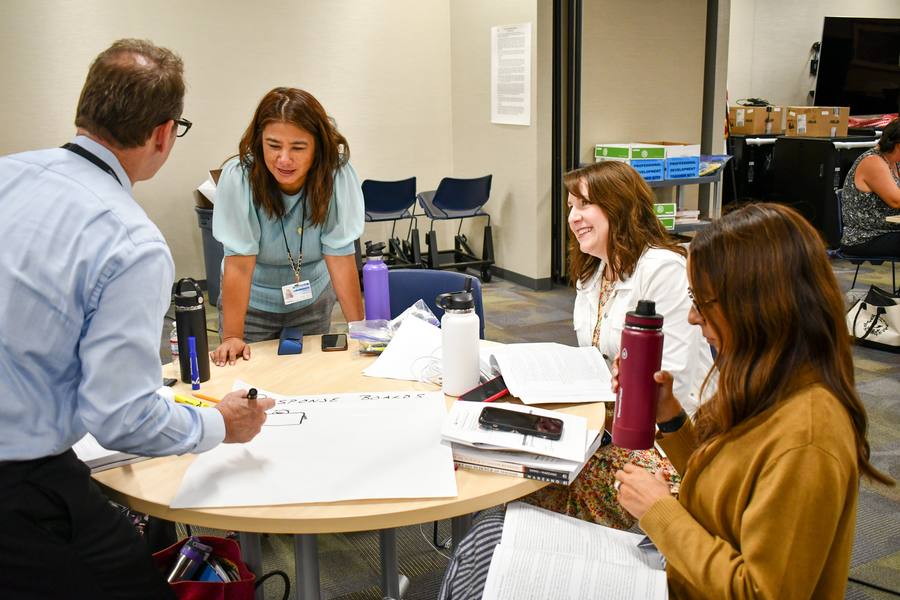 Leisa Winston at a table with educators during a professional learning session